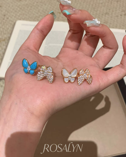 BUTTERFLY RING BETWEEN FINGERS